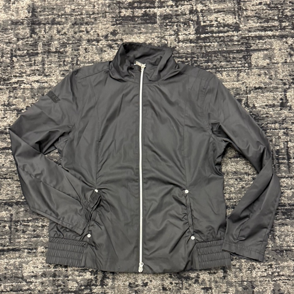 New Callaway women’s golf windbreaker with many pickets size large